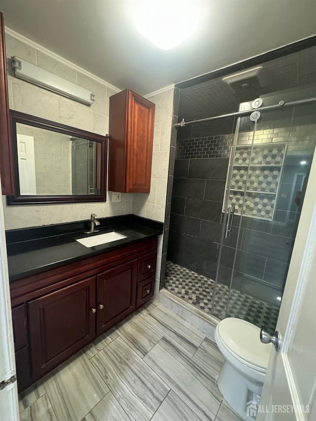 full bath with toilet, a shower stall, and vanity