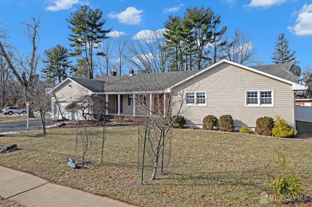 ranch-style house featuring a garage, a front yard, covered porch, and driveway