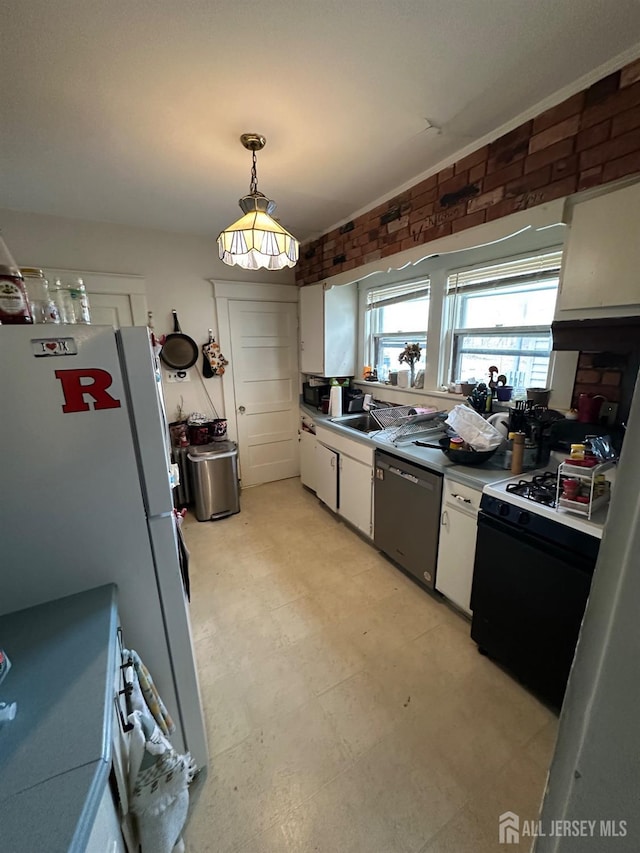 kitchen with light floors, white cabinetry, freestanding refrigerator, a sink, and stainless steel dishwasher