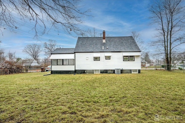 back of house with central AC and a yard