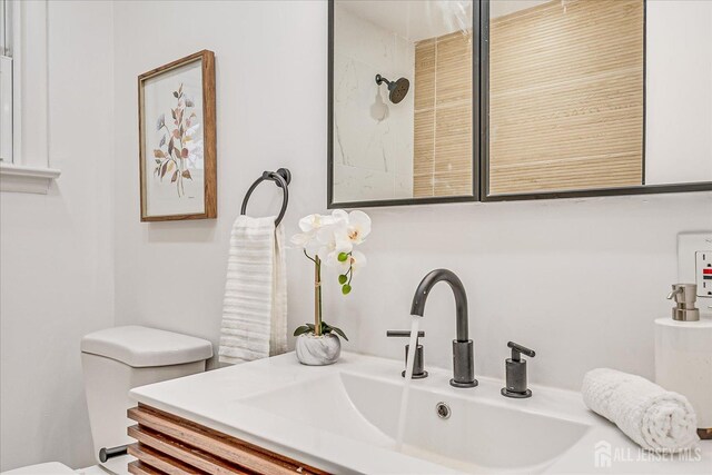 bathroom featuring toilet and vanity