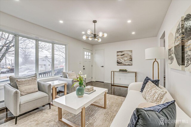 living room featuring a notable chandelier and light wood-type flooring