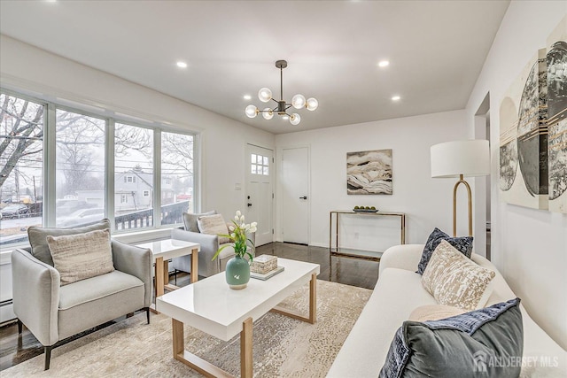 living room with light hardwood / wood-style floors and a chandelier