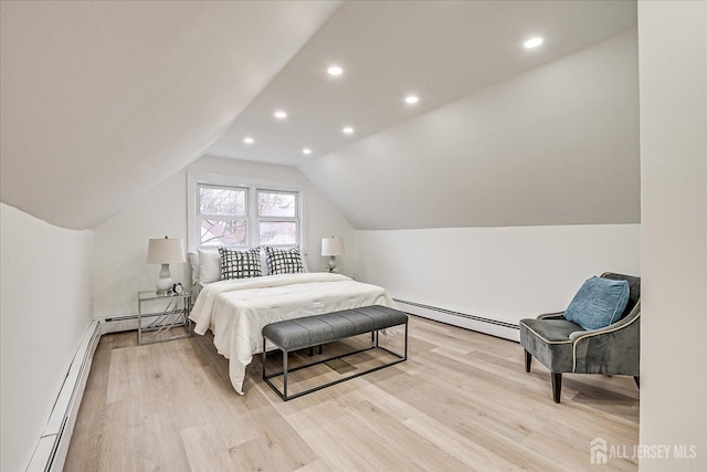 bedroom featuring light hardwood / wood-style floors, a baseboard heating unit, and lofted ceiling