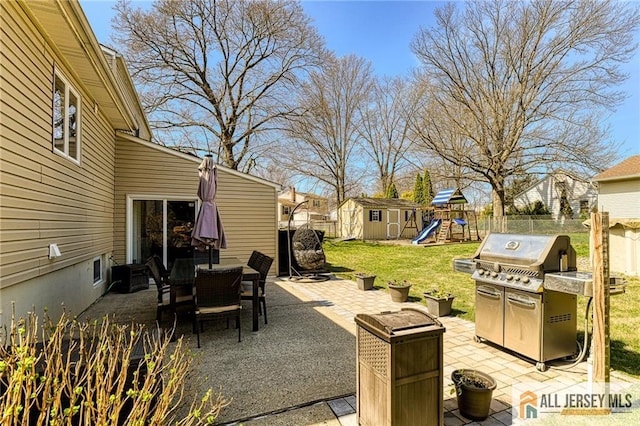 35 Outcalt Rd, Edison, NJ 08817 - view of patio / terrace featuring fence, grilling area, a storage unit, a playground, and outdoor dining space