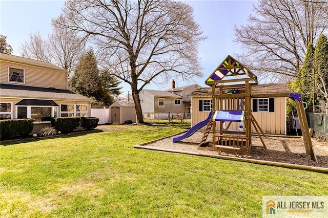 35 Outcalt Rd, Edison, NJ 08817 - view of playground featuring a storage unit, a lawn, fence, and an outbuilding