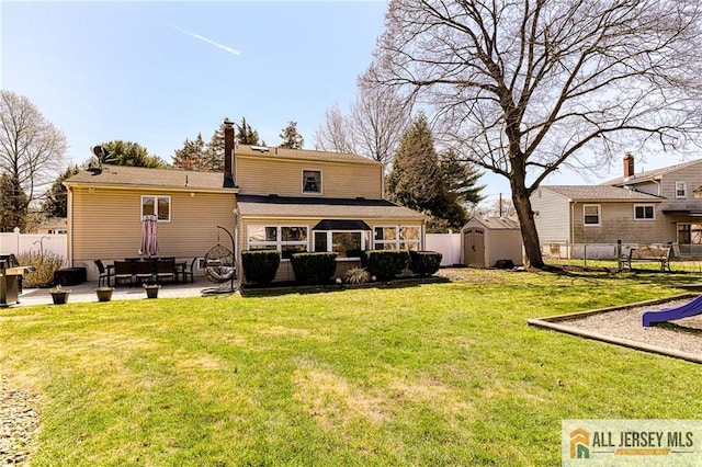 35 Outcalt Rd, Edison, NJ 08817 - rear view of property with a lawn, fence, an outdoor structure, a storage unit, and a patio