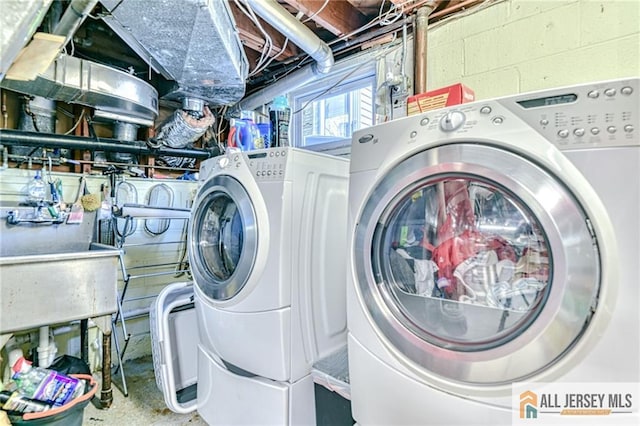 35 Outcalt Rd, Edison, NJ 08817 - laundry room featuring concrete block wall, laundry area, a sink, and washer and clothes dryer