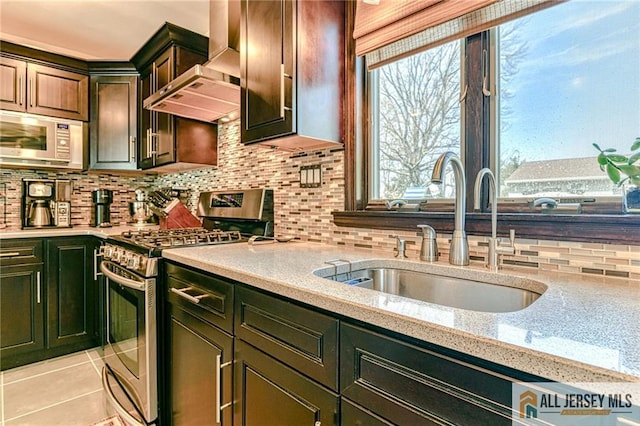 35 Outcalt Rd, Edison, NJ 08817 - kitchen featuring backsplash, appliances with stainless steel finishes, light stone countertops, a sink, and wall chimney exhaust hood