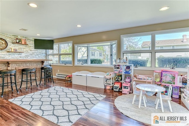 35 Outcalt Rd, Edison, NJ 08817 - playroom featuring baseboard heating, recessed lighting, wood finished floors, and a bar