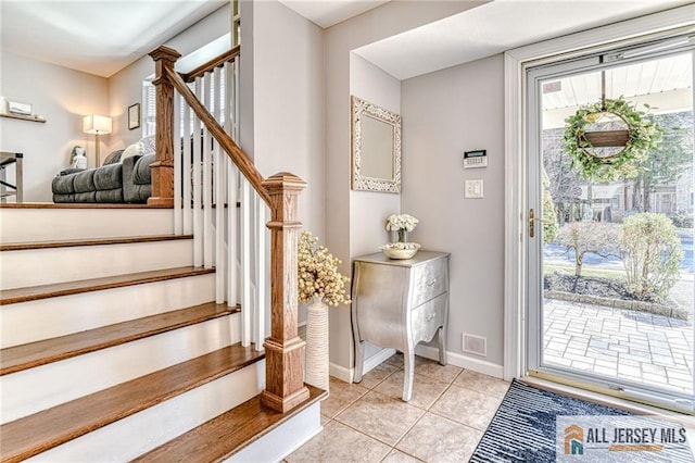 35 Outcalt Rd, Edison, NJ 08817 - foyer entrance with baseboards, light tile patterned flooring, and stairway