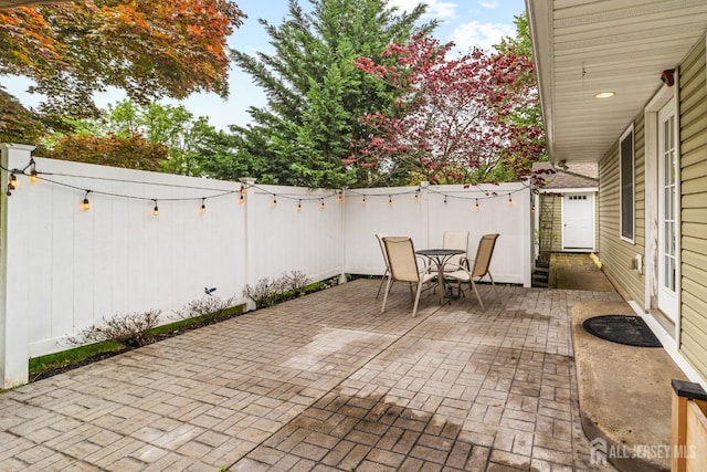 view of patio with outdoor dining area and a fenced backyard