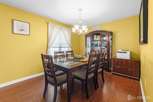 dining space with a chandelier, visible vents, baseboards, and dark wood-type flooring