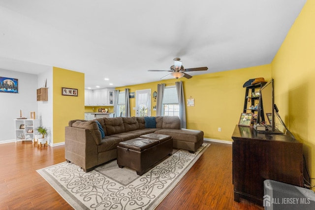 living area with wood finished floors, baseboards, ceiling fan, and recessed lighting