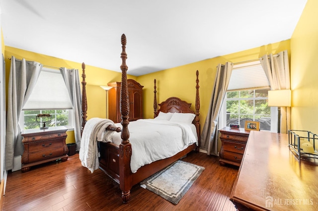 bedroom with dark wood-style flooring
