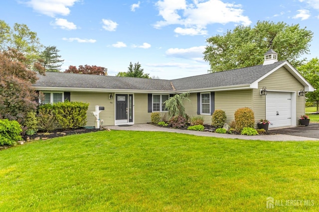 ranch-style house featuring a garage, a front lawn, a shingled roof, and driveway