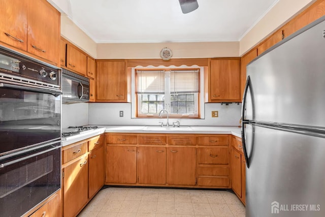 2347 Linden Ave, South Plainfield, NJ 07080 - kitchen with black appliances, a sink, light countertops, ornamental molding, and brown cabinets