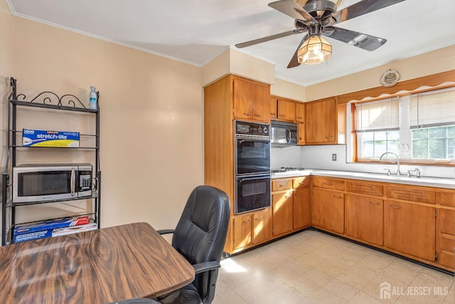 2347 Linden Ave, South Plainfield, NJ 07080 - kitchen with black appliances, a sink, light countertops, brown cabinets, and light flooring