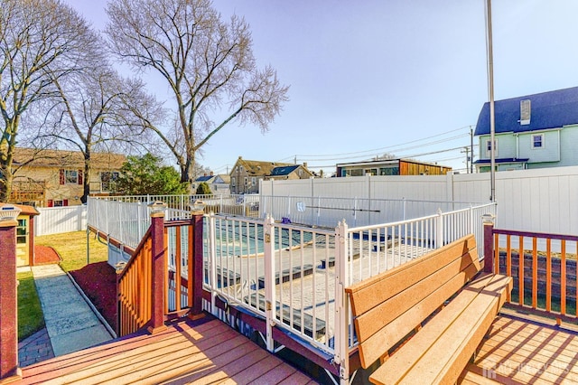 wooden deck featuring a fenced backyard