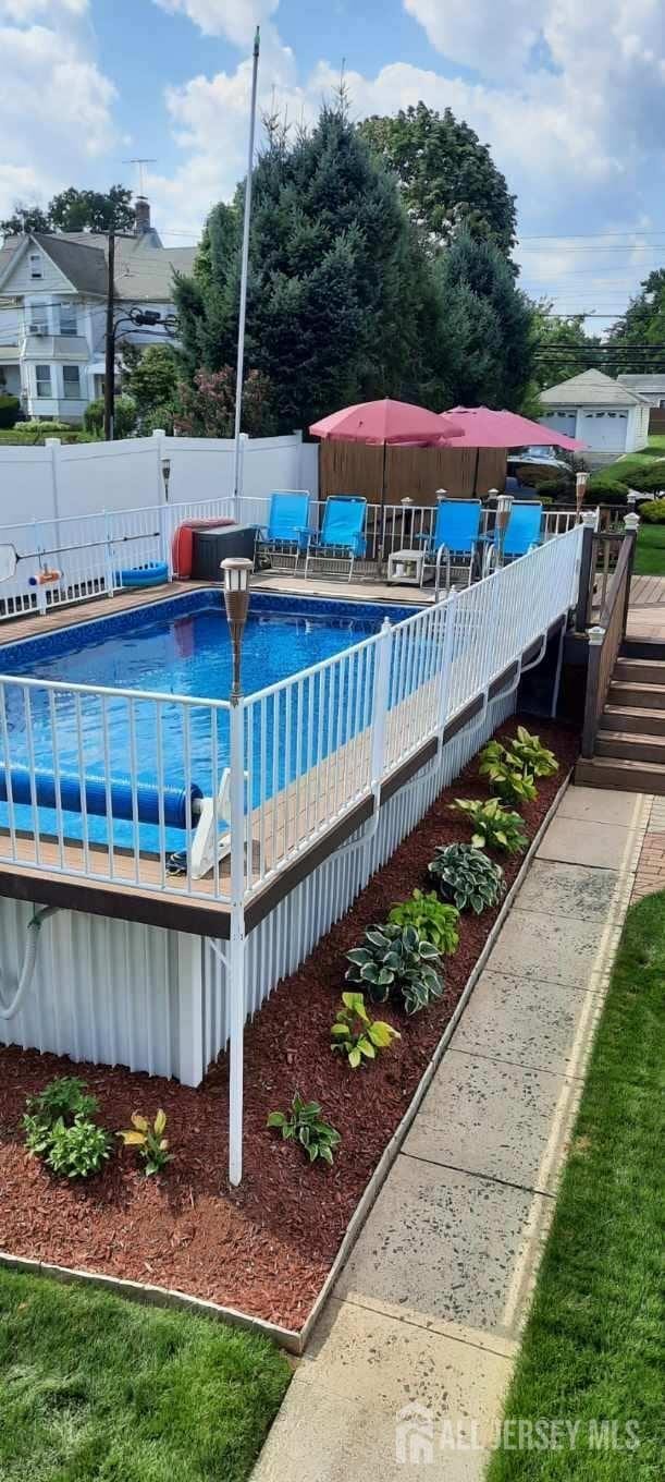 view of swimming pool with a fenced in pool and fence