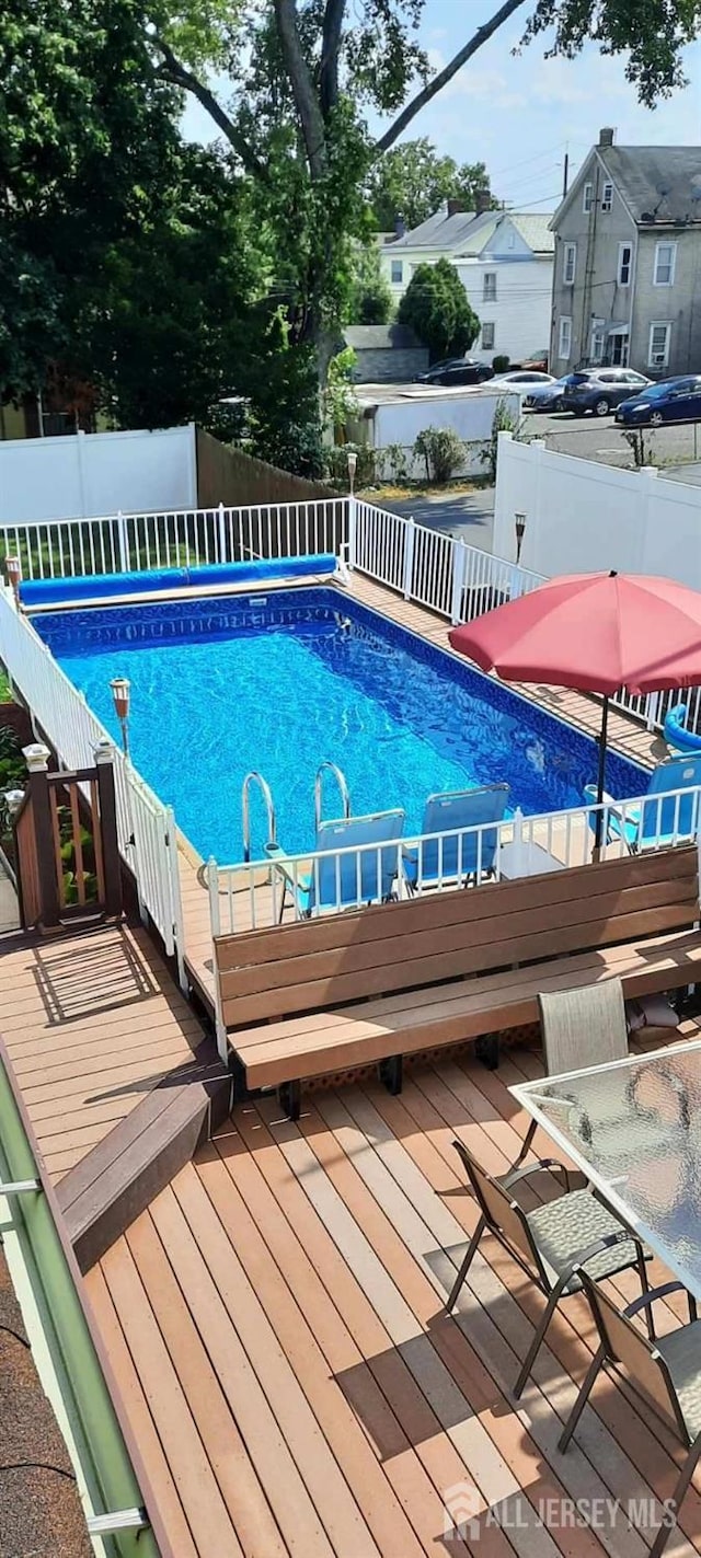 outdoor pool featuring a residential view and a fenced backyard