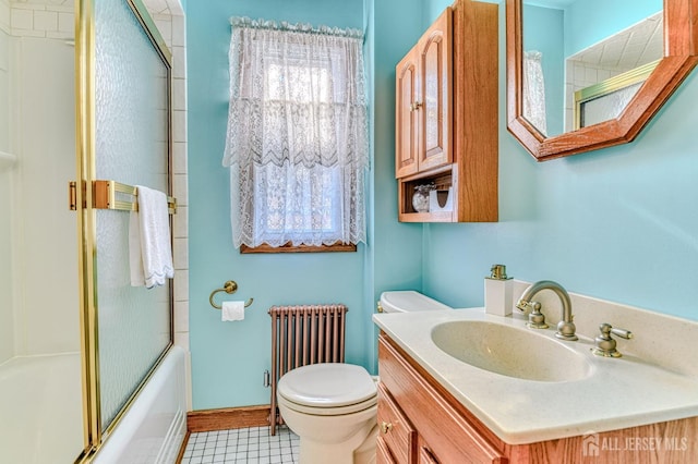 bathroom featuring toilet, radiator heating unit, baseboards, bath / shower combo with glass door, and vanity