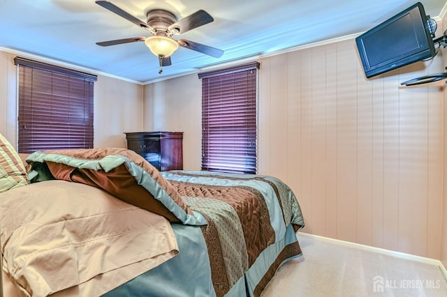 bedroom with crown molding, baseboards, carpet floors, and ceiling fan