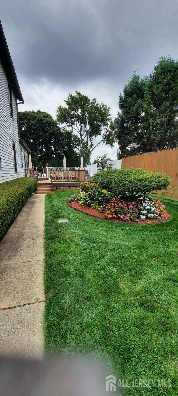 view of yard featuring a deck and fence