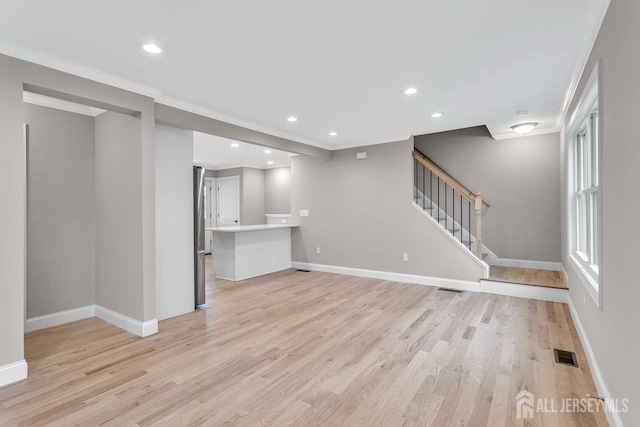 64 2nd Ave, Port Reading, NJ 07064 - unfurnished living room featuring light wood-type flooring, baseboards, crown molding, recessed lighting, and stairway