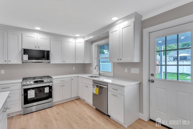 64 2nd Ave, Port Reading, NJ 07064 - kitchen featuring stainless steel appliances, a sink, plenty of natural light, light countertops, and recessed lighting