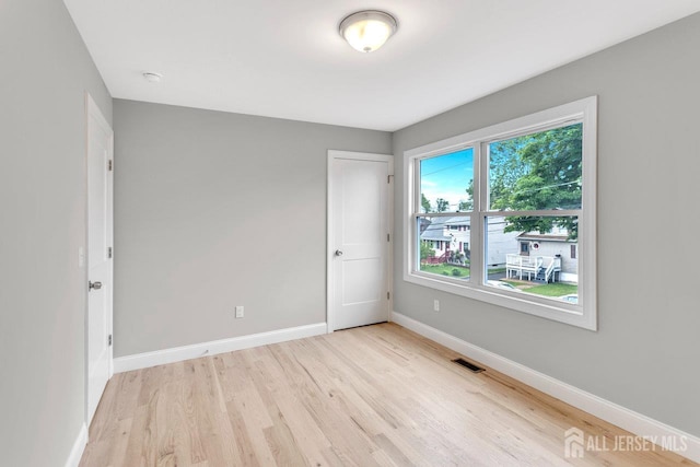 64 2nd Ave, Port Reading, NJ 07064 - empty room with light wood-style floors, baseboards, and a smoke detector