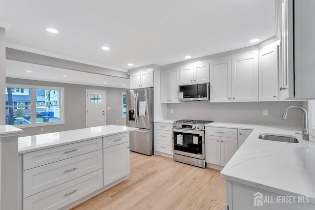 64 2nd Ave, Port Reading, NJ 07064 - kitchen featuring stainless steel appliances, a sink, light stone counters, light wood-style flooring, and crown molding