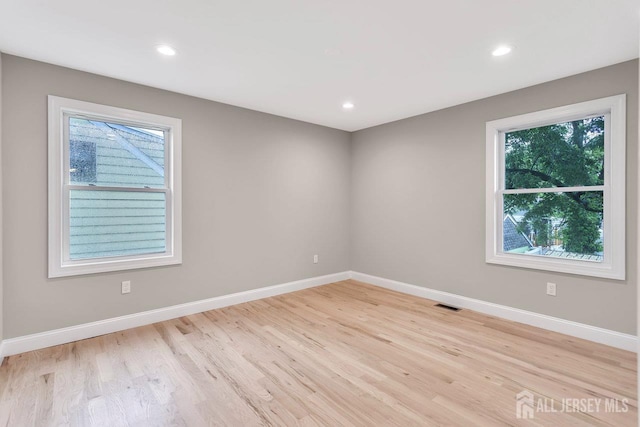 64 2nd Ave, Port Reading, NJ 07064 - empty room featuring plenty of natural light, baseboards, light wood-style flooring, and recessed lighting