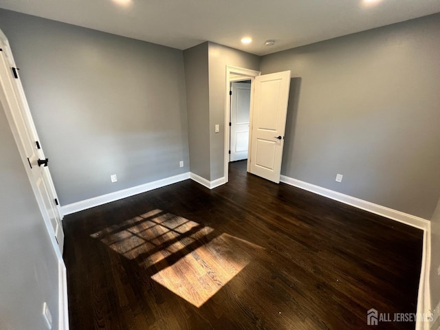 unfurnished bedroom featuring dark hardwood / wood-style floors