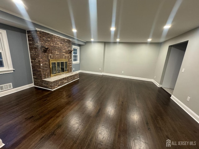 unfurnished living room with a fireplace and dark hardwood / wood-style floors