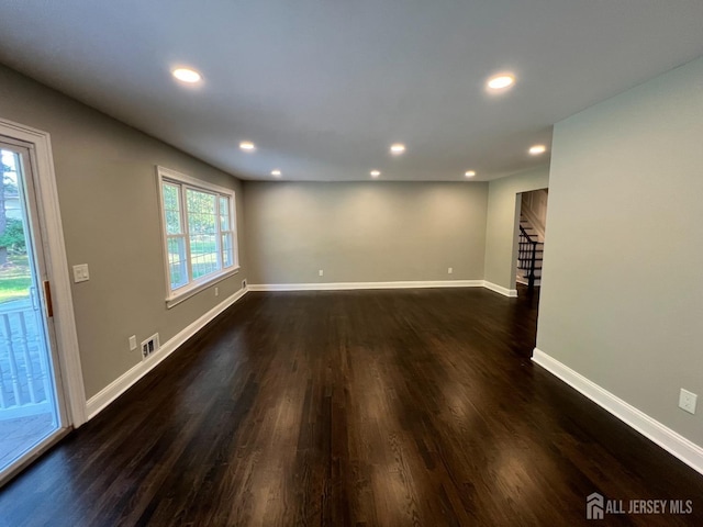 spare room with dark wood-type flooring