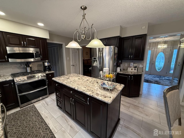 4 Hemlock Hill Rd, Jackson, NJ 08527 - kitchen with appliances with stainless steel finishes, light stone counters, decorative light fixtures, recessed lighting, and a kitchen island