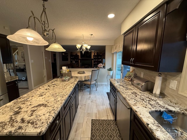 4 Hemlock Hill Rd, Jackson, NJ 08527 - kitchen with a chandelier, a center island, tasteful backsplash, light stone counters, and a textured ceiling