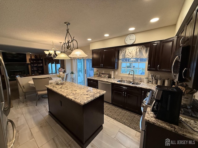 4 Hemlock Hill Rd, Jackson, NJ 08527 - kitchen featuring stainless steel appliances, a kitchen island, light stone countertops, a textured ceiling, and recessed lighting