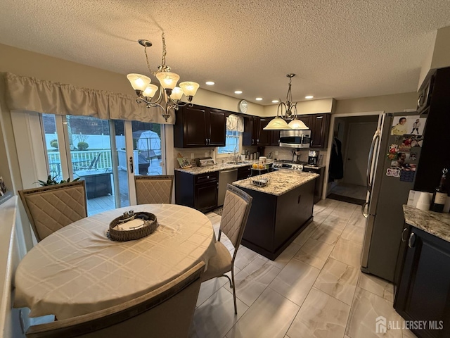 4 Hemlock Hill Rd, Jackson, NJ 08527 - kitchen featuring appliances with stainless steel finishes, a kitchen island, a chandelier, plenty of natural light, and a textured ceiling