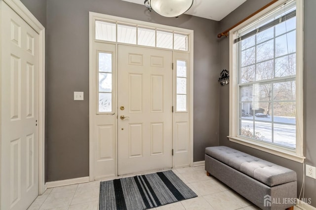 foyer entrance with light tile patterned floors