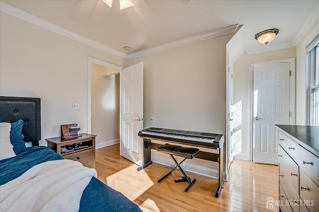 bedroom with baseboards, light wood-style floors, and crown molding