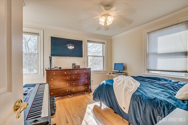 bedroom with ceiling fan, heating unit, wood finished floors, and crown molding