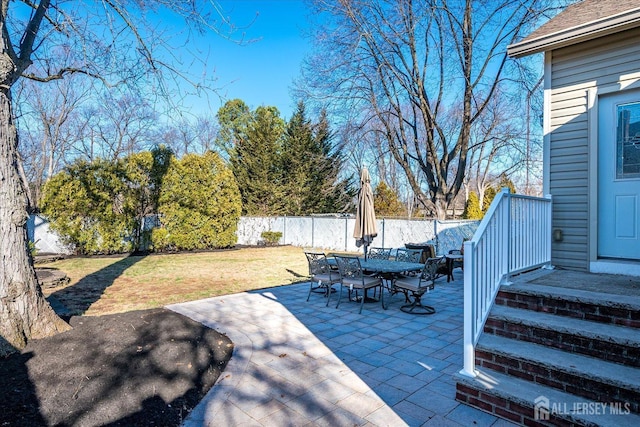 view of patio with outdoor dining area and a fenced backyard