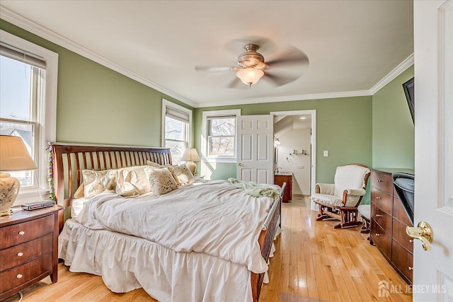 bedroom featuring a ceiling fan, crown molding, and light wood-style floors