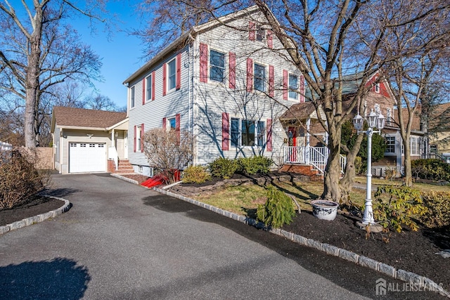 view of front facade featuring aphalt driveway and a garage