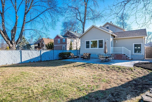 rear view of property with a lawn, a patio, and fence