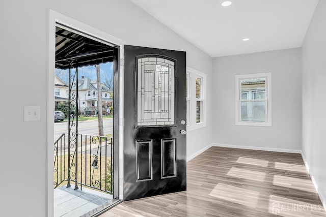 211 S Washington Ave, Dunellen, NJ 08812 - entryway with healthy amount of natural light, wood finished floors, baseboards, lofted ceiling, and recessed lighting