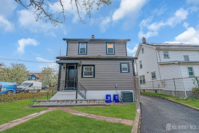 211 S Washington Ave, Dunellen, NJ 08812 - rear view of property with central air condition unit and a chimney