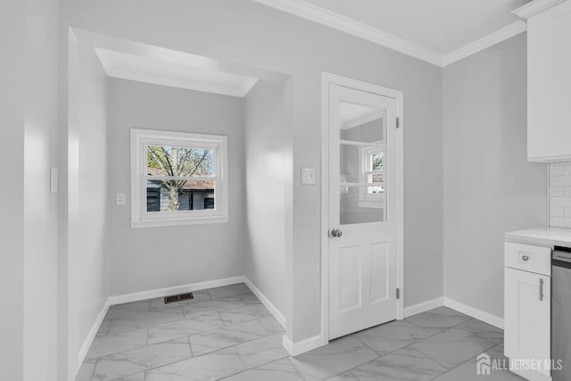 doorway featuring light marble finish floors, baseboards, and crown molding